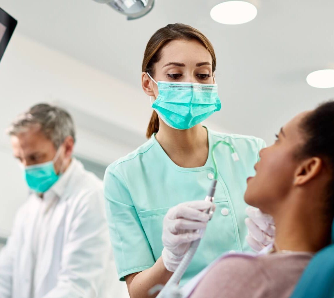 Patient Sitting In Dental Chair During Examination