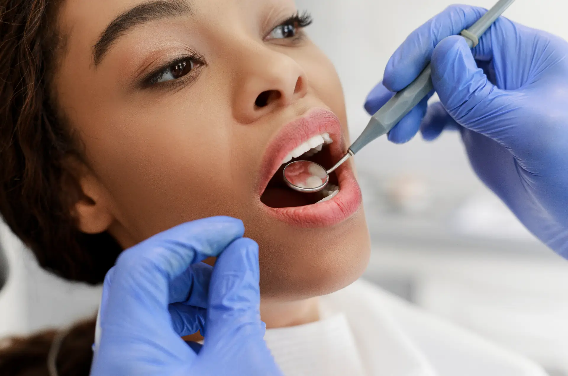 Patient Receiving Dental Check-Up From Dentist