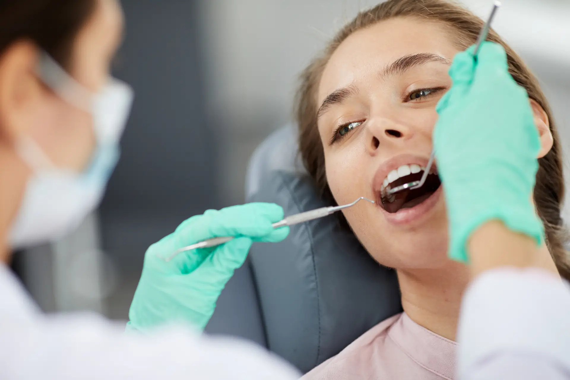 Patient Receiving Dental Check-Up From Dentist