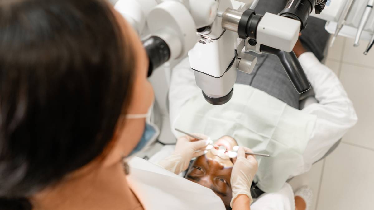 A picture from a higher view showing a dentist doing work on the patient