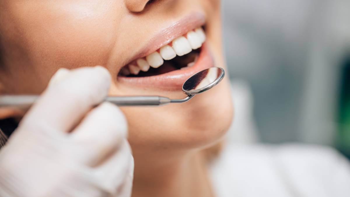 Close up of mouth and dentist equipment