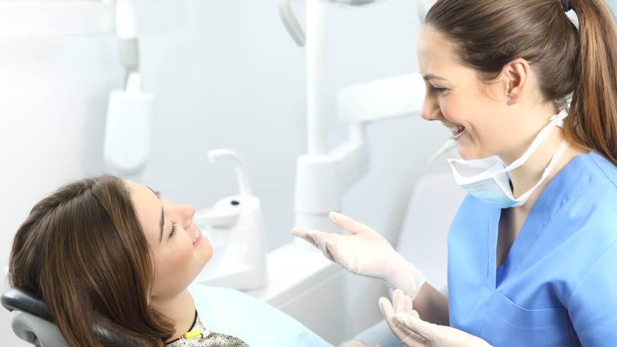 Dentist and patient smiling at each other
