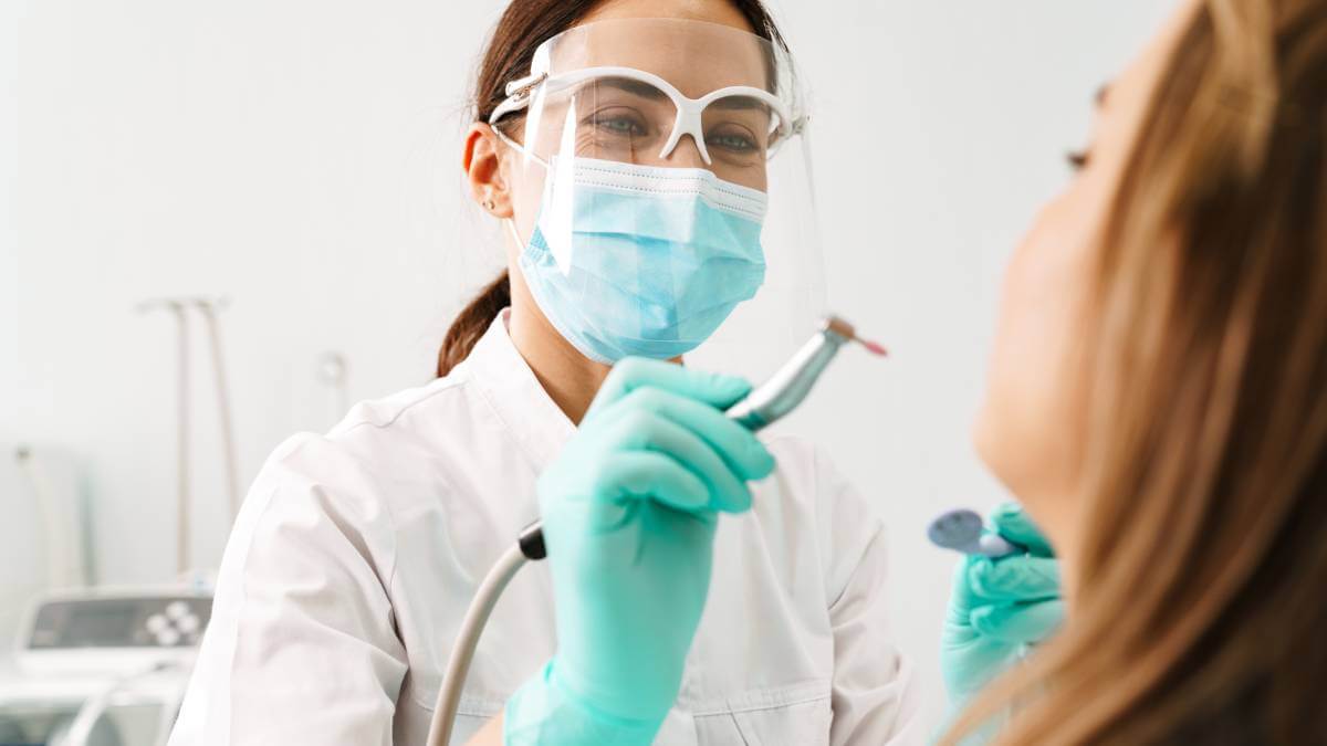 Dentist wearing face sheild
